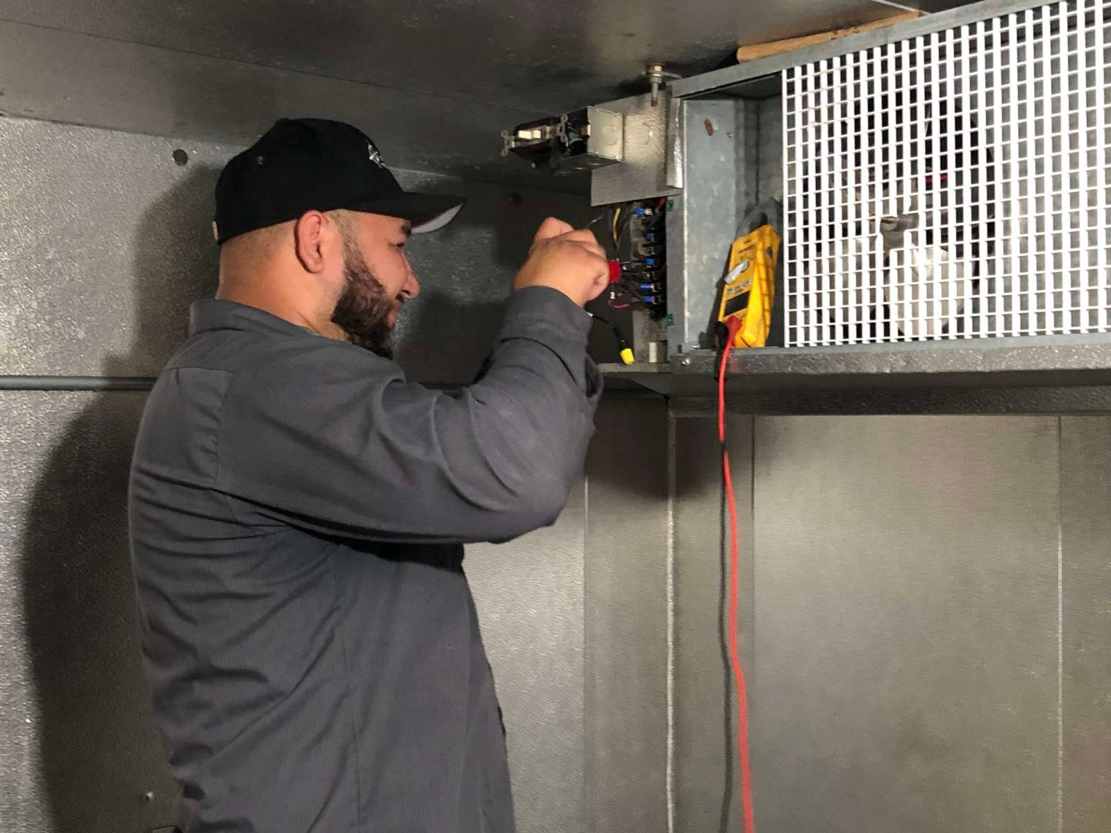 Technician repairing a commercial walk-in cooler