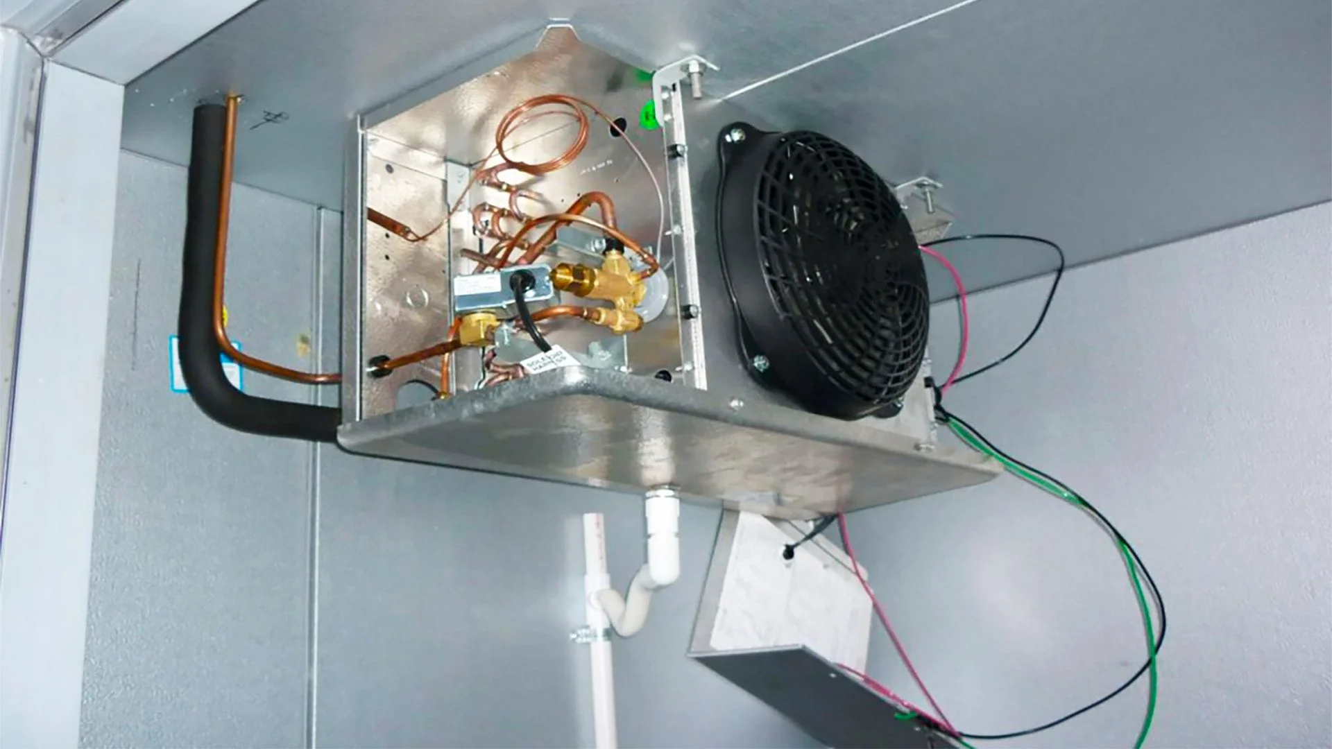 Technician repairing a walk-in and reach-in commercial freezer